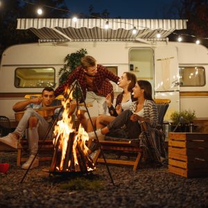 Friends cooking on campfire, picnic at camping