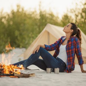 Tourist Woman in the Camp Near Campfire