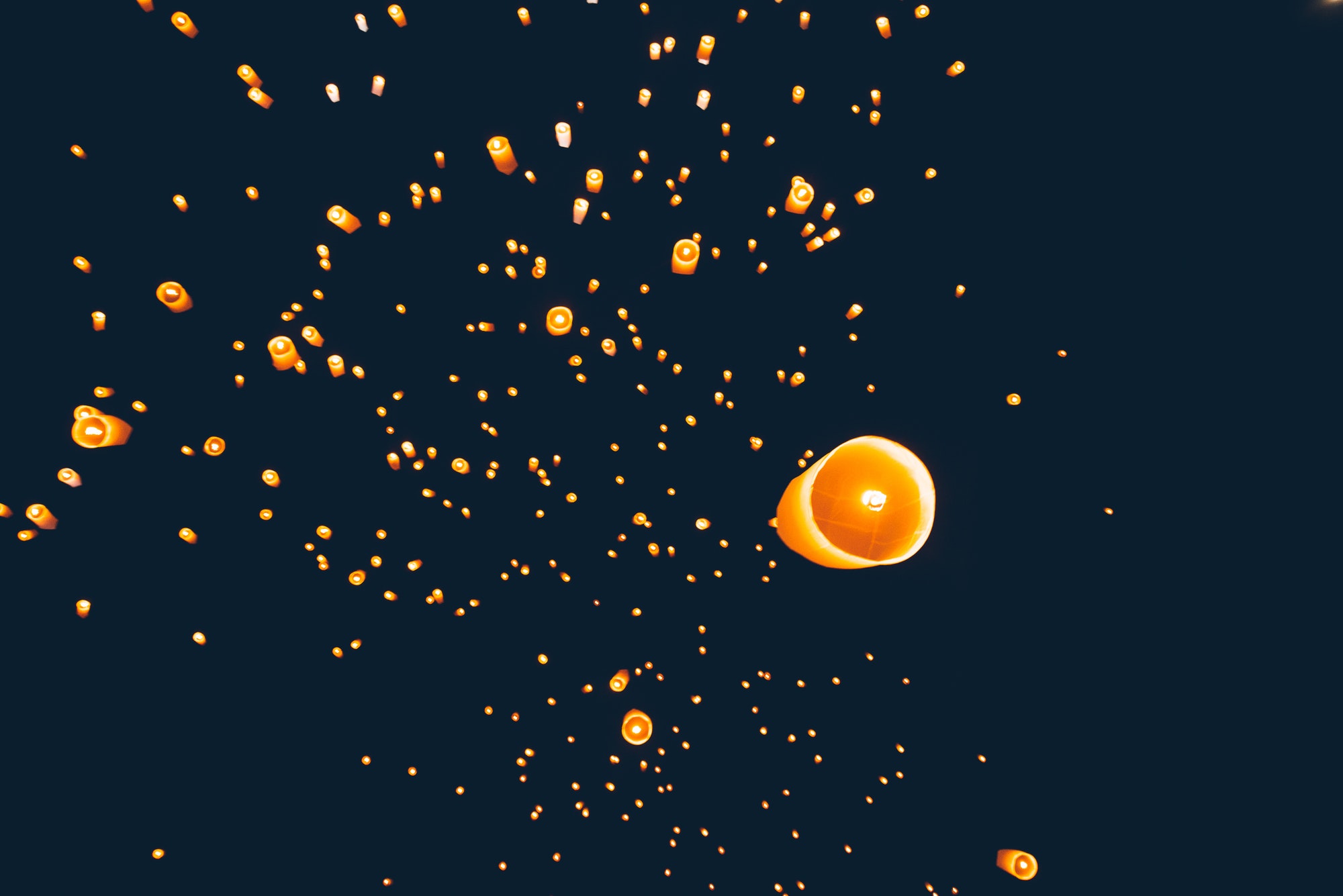 Loy krathong festival, thai new year party with floating lanterns release in the night sky